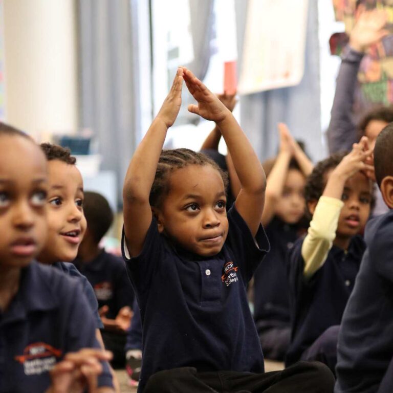 NECP student stretching and singing in class